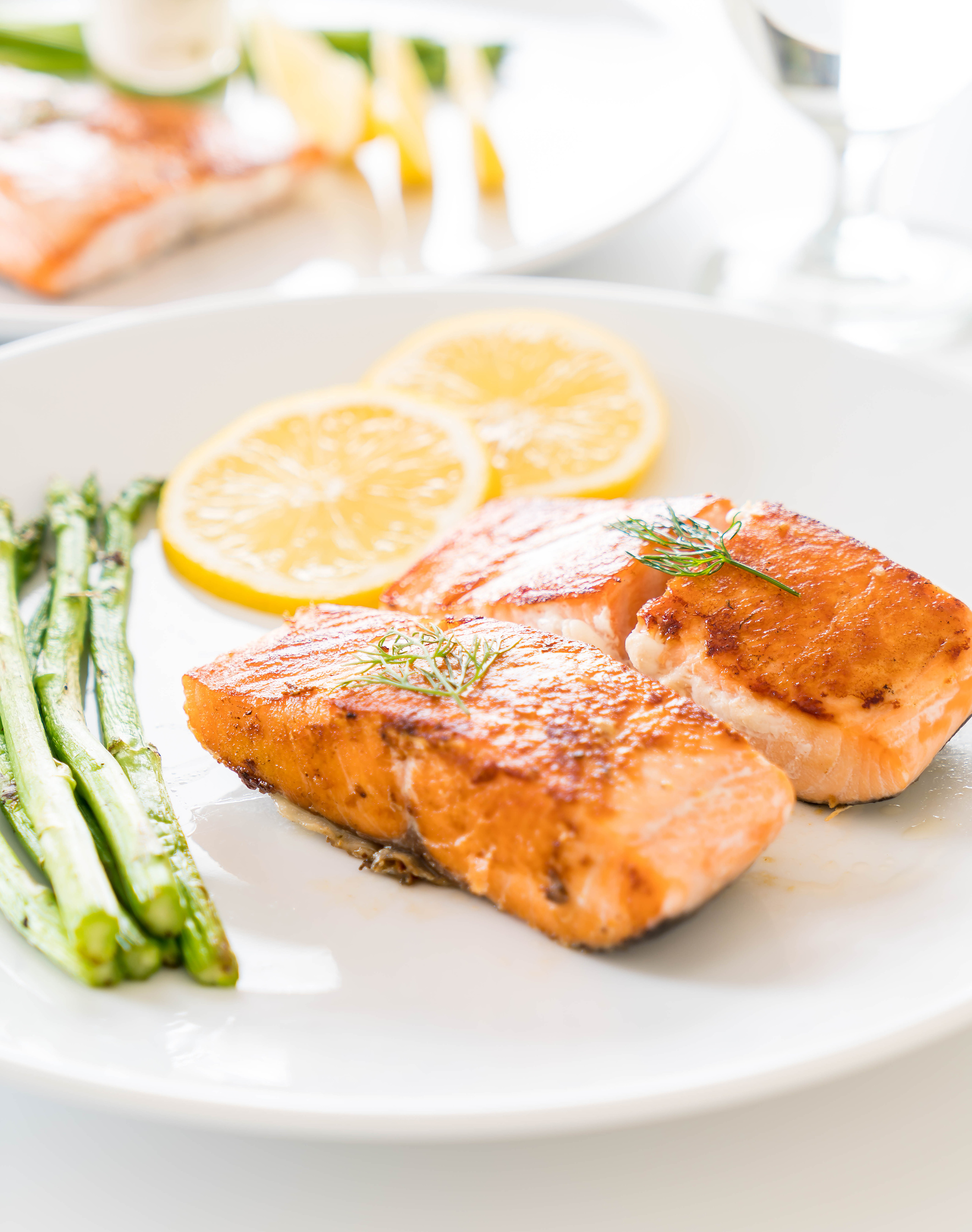 Grilled Salmon Steak with Lemon and Asparagus on a Plate